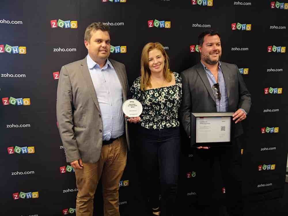 A image of DSL Telecom's Directors holding the Zoho partner of the year SA 2022 award. 