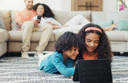 Kids playing on a tablet with Vox Link Layer’s stable fibre-to-the-home internet connection in South Africa