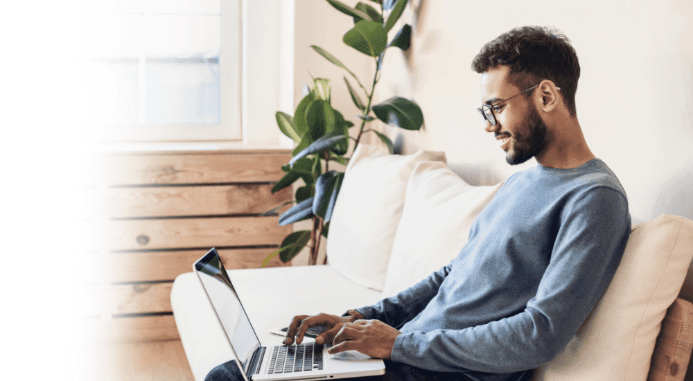 A male browsing the internet seamlessly with a Vox Openserve fibre internet connection