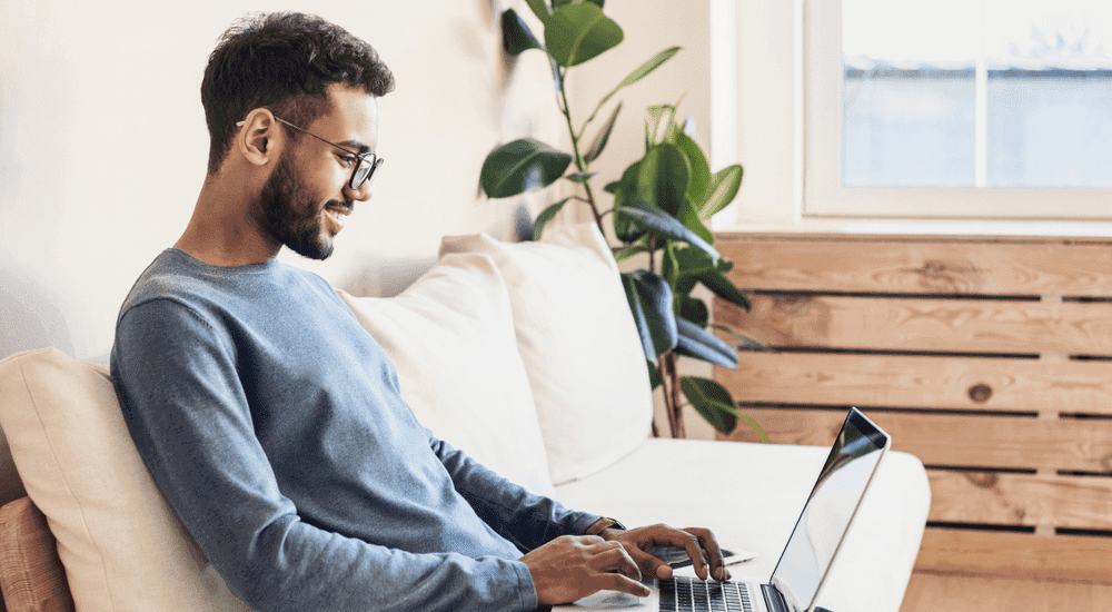 A male browsing the internet seamlessly with a Vox Openserve fibre internet connection