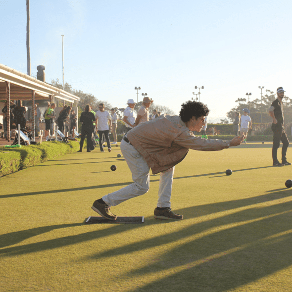 A DSL Telecom teammate playing lawn bowls at our mid-year event