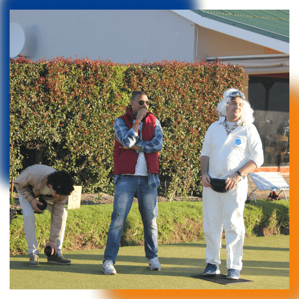 DSL Telecom team members watching other teams compete in the lawn bowls tournament.