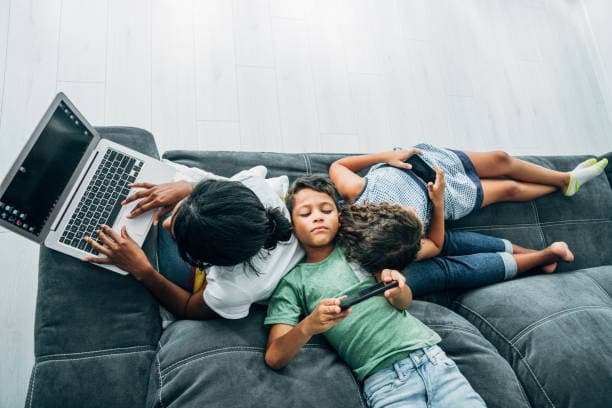 Kids on multiple devices at home with a free Wi-Fi router included in Telkom Frogfoot fibre deals for strong reliable internet coverage