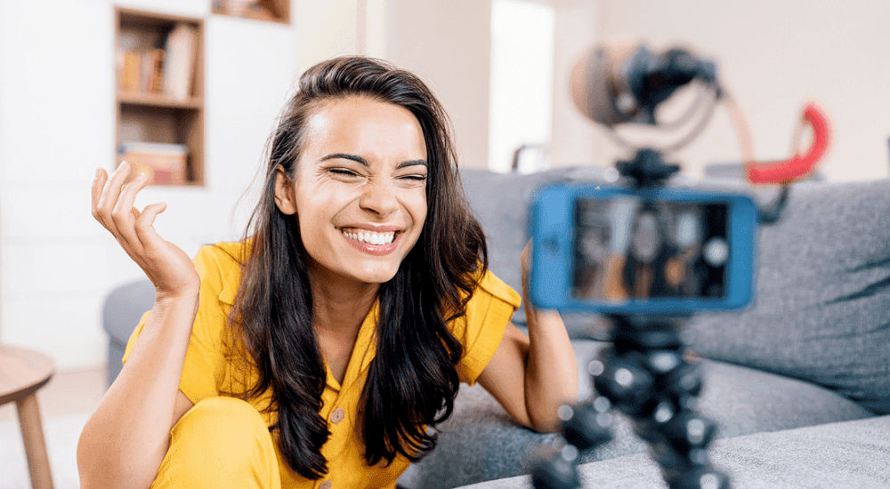 A woman filming live on social media with lightning-fast Vox TT Connect fibre 