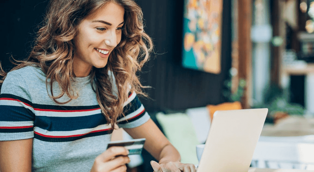 A lady shopping online with zero interruptions and enjoying a Vox Octotel fibre internet connection