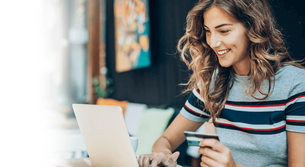 A lady shopping online with zero interruptions and enjoying a Vox Octotel fibre internet connection