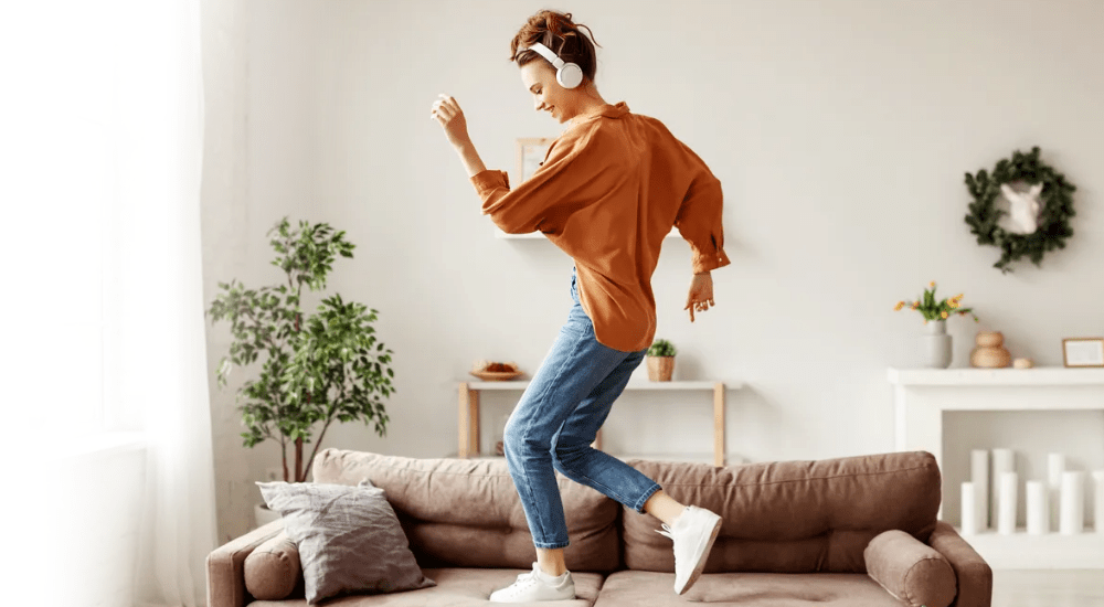 A young lady streaming music at home with her fast uncapped Evotel fibre internet connection