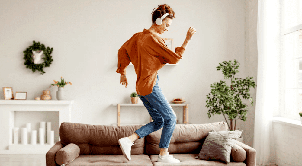 A young lady streaming music at home with her fast uncapped Evotel fibre internet connection