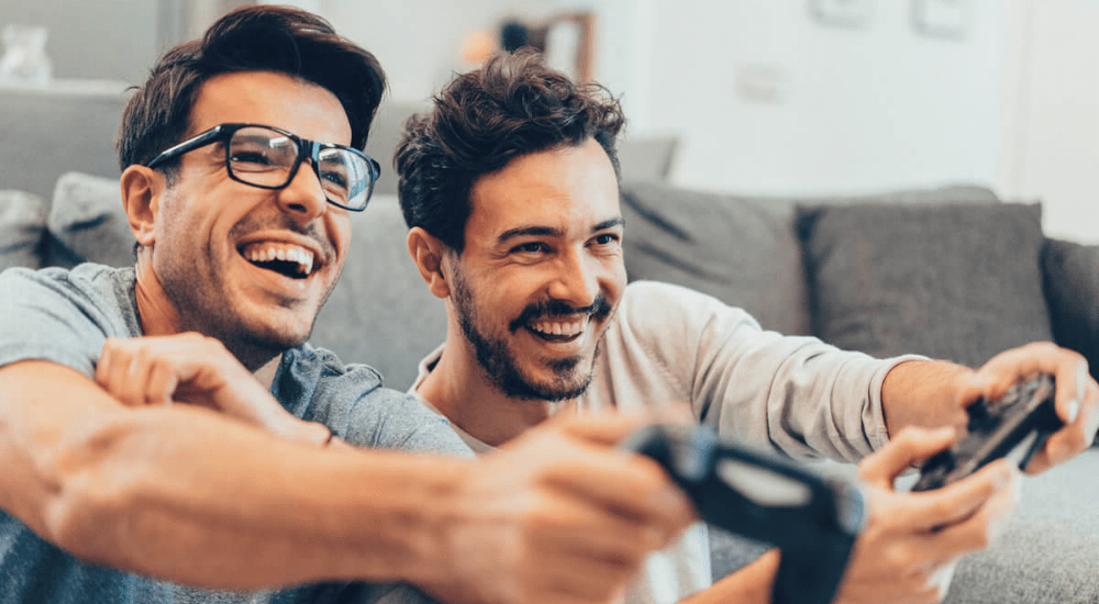 Two guys playing video games online using a Telkom LTE internet connection