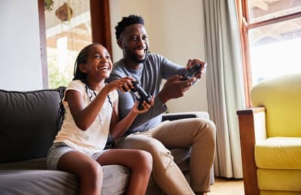 Father and daughter playing online games with fast Telkom Link Africa fibre speeds from DSL Telecom in South Africa.