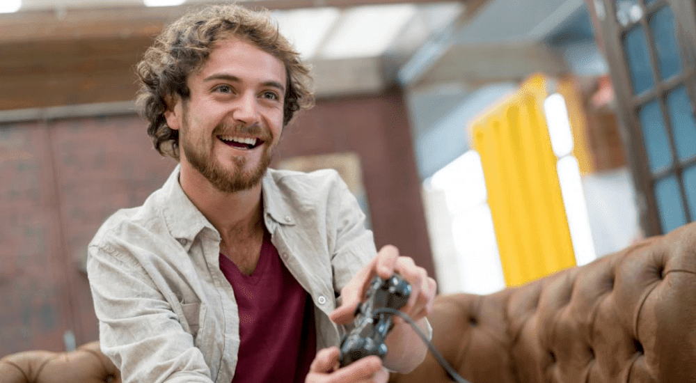 A man playing video games connected to his home fibre connection