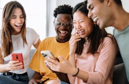 Friends enjoying streaming videos on multiple devices with fast Telkom Vuma fibre internet.