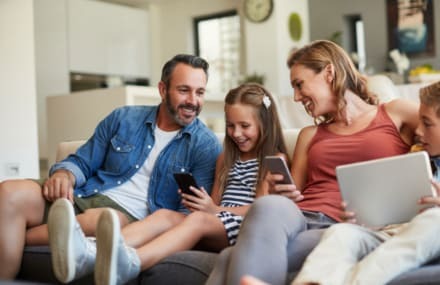 Family enjoying Telkom fibre with a Wi-Fi router connecting multiple devices for high-speed internet in South Africa