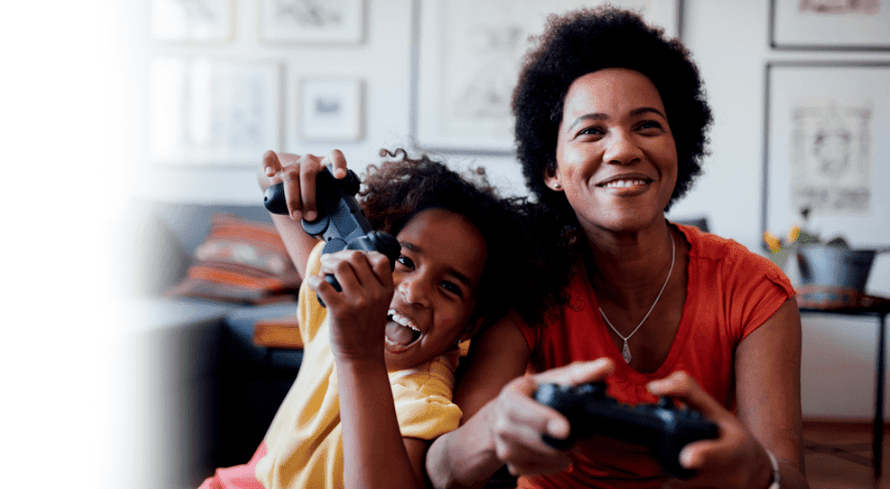 A family playing online video games connected to their Vox Vodacom fibre to the home internet connection