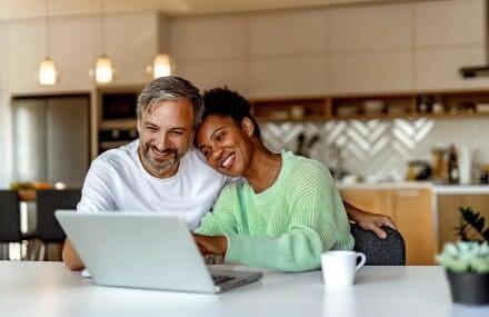 Married couple browsing the internet using Vox Link Layer’s affordable fibre internet packages in South Africa