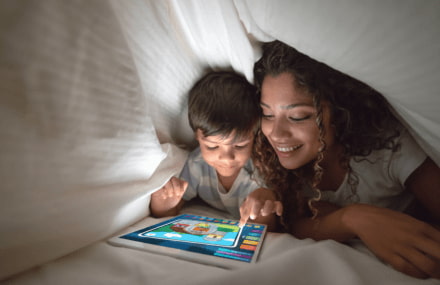 Mother and child watching a kids show on their iPad using Vox Metrofibre’s reliable home fibre.
