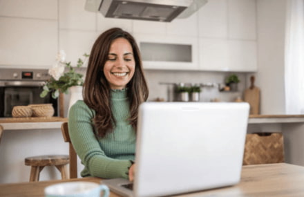 Lady working from home on her laptop with a stable and reliable Vox Metrofibre fibre connection.