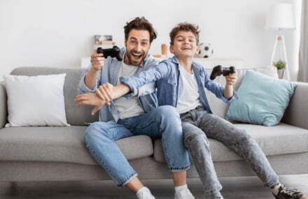 Father and son playing online games using Vox Netstream’s fast, reliable fibre connection in South Africa