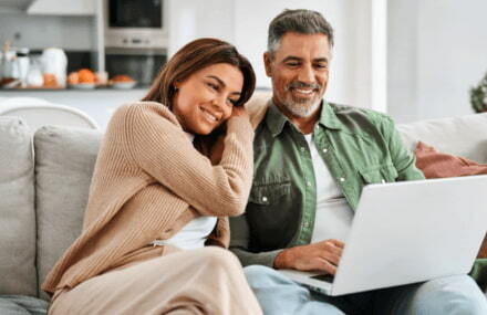 A couple browsing the internet with a reliable Vox Netstream fibre internet connection at home in South Africa