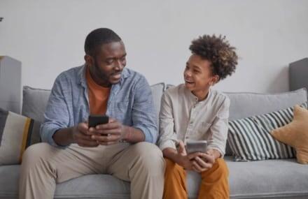 Father and son streaming videos on their phones using Vox Octotel fibre connection