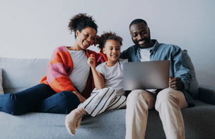 Family sitting on the couch watching movies with fast and reliable Vox Octotel fibre internet