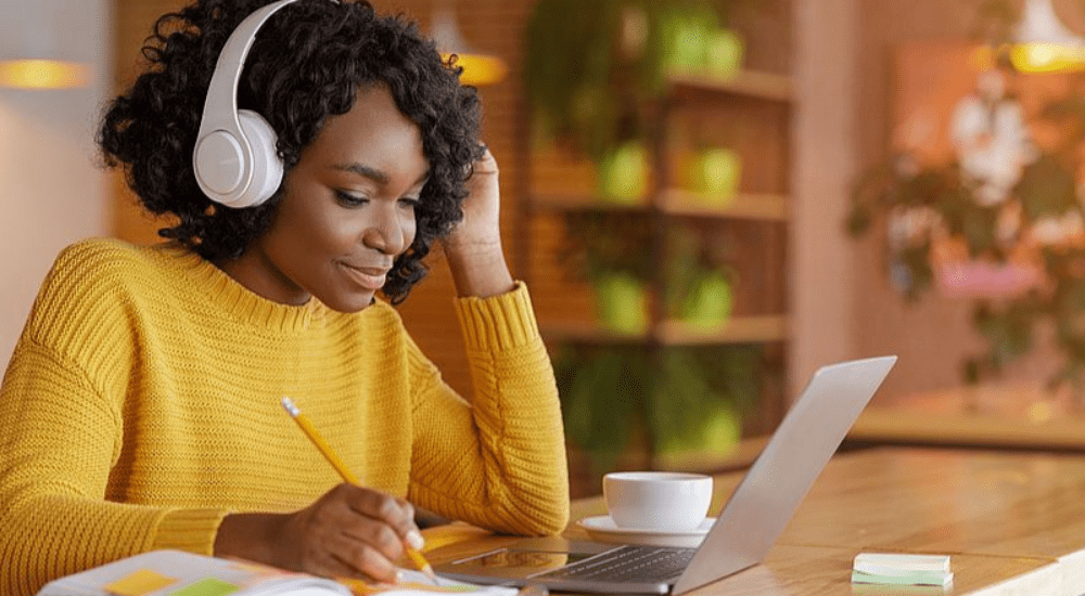 A young lady streaming music at home with her fast uncapped Evotel fibre internet connection