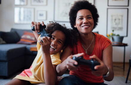 Mother and daughter enjoying online gaming together with Vox Vodacom’s high-speed fibre network.