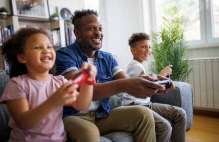 Family playing online video games with a fast and reliable Vox Vuma fibre connection