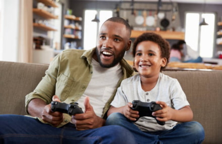 Father and son playing online games using Vox Zoom’s stable fibre-to-the-home internet connection in South Africa