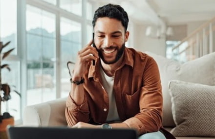 Man making a phone call from his couch using Vox’s 60-minute free voice calling service