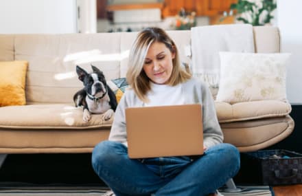 Lady working from home on her laptop with Vox Vuma’s stable fibre internet connection