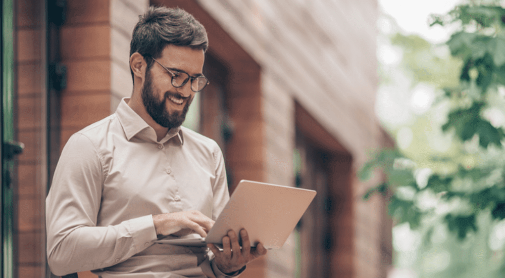 A remote worker working outside connected to his high-speed reliable satellite internet