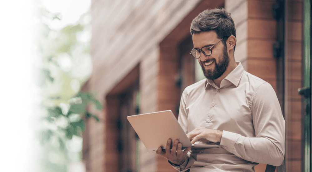 A remote worker working outside connected to his high-speed reliable satellite internet