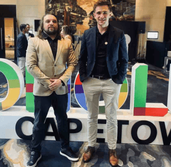 Zoho consultants in front of Zoholics Cape Town sign
