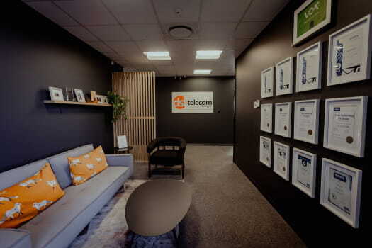 Entrance of DSL Telecom office showcasing a wall of professional Zoho certifications and achievements