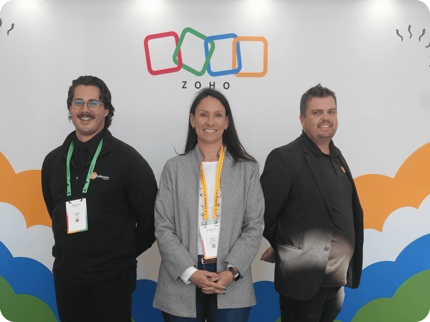 DSL Telecom team members with a DSL Telecom customer in front of the Zoholics Cape Town 2026 backdrop