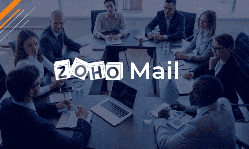 A group of people at a boardroom table, listening to man give Zoho Mail training 