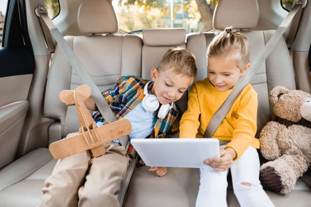 Children using iPads in the car on a road trip across South Africa with Telkom LTE mobile data, perfect for on-the-go wireless internet.