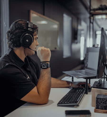 Employee taking a business VoIP call on a headset at a DSL Telecom workstation