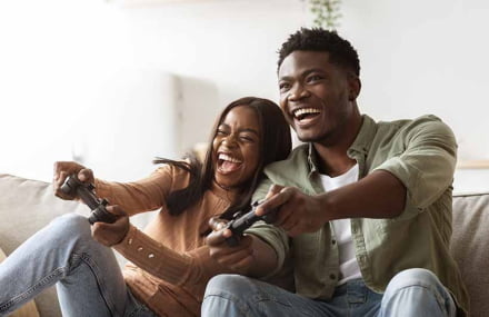Couple playing online games with a lightning-fast Vox Evotel fibre internet connection in South Africa